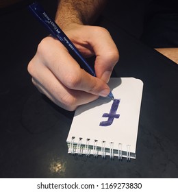 Doodling Facebook Logo On A Notepad