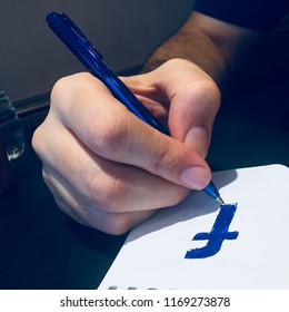 Doodling Facebook Logo On A Notepad