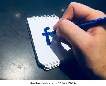 Doodling Facebook Logo On A Notepad