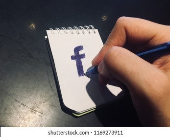 Doodling Facebook Logo On A Notepad