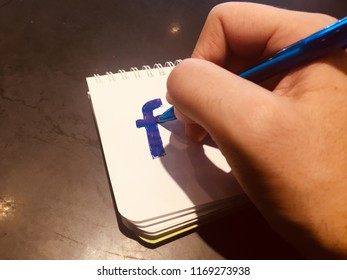 Doodling Facebook Logo On A Notepad