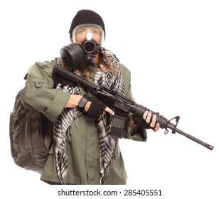 DOOMSDAY PREPPER | Environmental Disaster. Post Apocalyptic Female Survivor Wearing A Gas Mask And Rifle Looking At Camera With Her Go Bag.