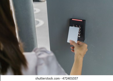 Door access control with a hand inserting key card to lock and unlock door. Security concept.