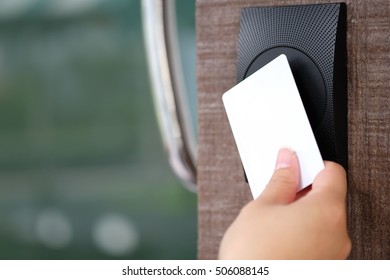 Door access control with a hand inserting key card to lock and unlock door.