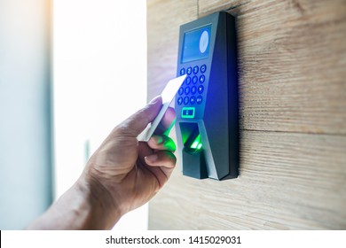 Door access control. Staff holding a key card to lock and unlock door at home or condominium. using electronic card key for access. electronic key and finger scan access control system to unlock doors - Shutterstock ID 1415029031