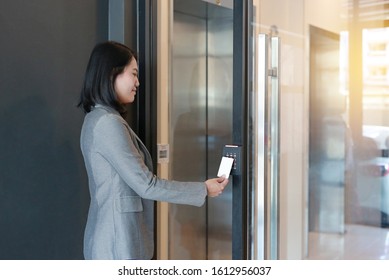 Door Access Control - Young Officer Woman Holding A Key Card To Lock And Unlock Door For Access Entry.