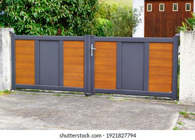 door aluminum grey and wooden brown gate portal of suburb house