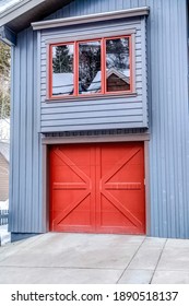 Door Of An Attached Single Car Garage Of Home With Gray Exterior Wall Siding