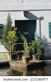 Door Of A Bavarian House In Front Of A Water With Plants