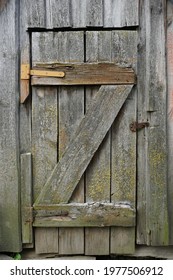    The Door From The Boards To The Cellar. Retro. Old Awnings And Rusty Nails. Vertical Shot                            