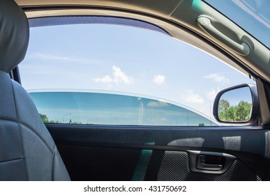 The door car open window glass with blue sky view.
