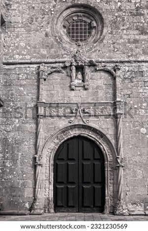 Door, circular window and stone work of the sixteenth century Azurara mother church, Vila do Conde, Portugal