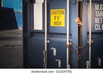 The door of a container which was covered with iron chains and keys, inside of which several people, to human trafficking and illegal immigration concept.
