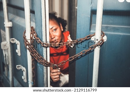 The door of a container which was covered with iron chains and keys, inside of which several African American woman, to human trafficking and illegal immigration concept.