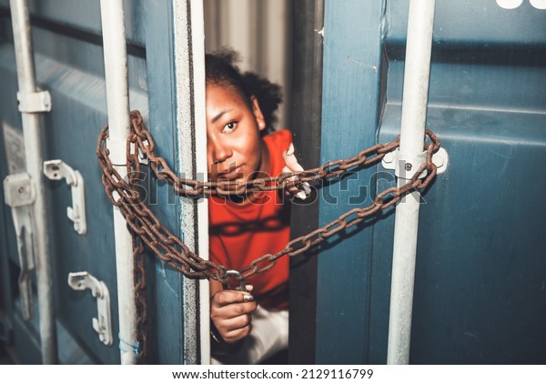 The door of\
a container which was covered with iron chains and keys, inside of\
which several African American woman, to human trafficking and\
illegal immigration\
concept.