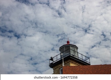 Door County Lighthouse Along Lake Michigan, In Front Of Puffy Clouds