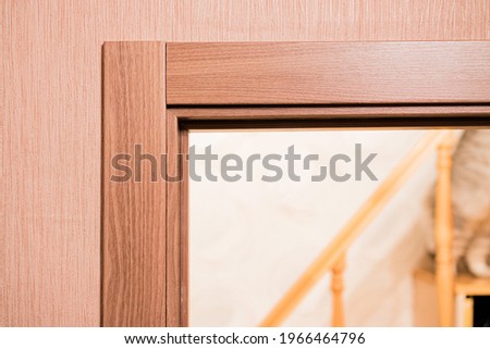 Door frame with architrave of a brand new installed door into the bedroom  with wooden staircase. Design. Style. Interior. Housing