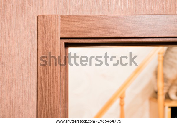 Door frame with architrave of a brand new
installed door into the bedroom  with wooden staircase. Design.
Style. Interior. Housing
