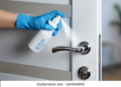 Door handle disinfection for the prevention of viral infection during the COVID-19 pandemic. White door. Door knob.