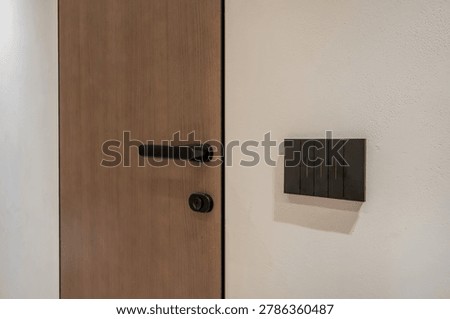 door handle and light switch next to it in a bright room or office