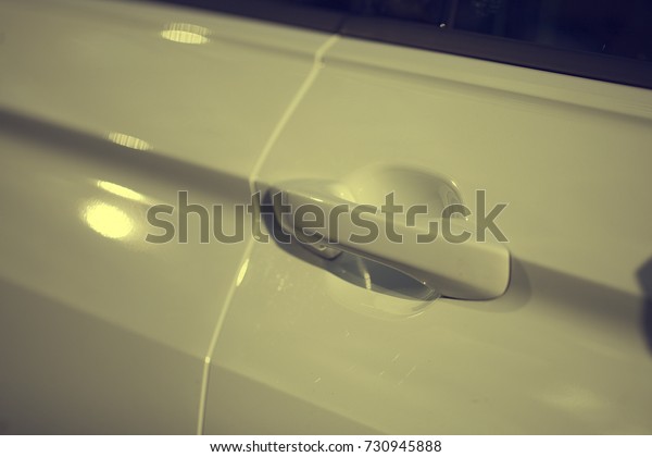 door handle of modern white\
car