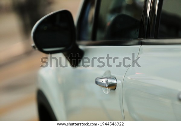 door handle of a white car, soft focus. white automobile\
handle. 