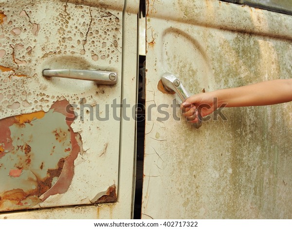 door\
handle/children hand on door handle of old van\
car.