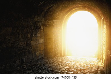 Door to Heaven. Arched passage open to heaven`s sky. Light at end of the tunnel. Hope metaphor.