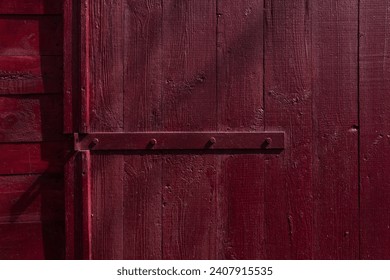 The door hinges are painted red. Small depth of field 