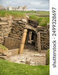 Door to a house in a stone wall, in the neolithic village of Skara Brae, Sandwick, Orkney, Scotland