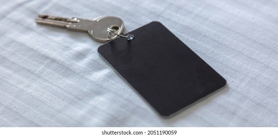 Door Key With Blank Label. Steel Key Ring, Room Key And Empty Black Tag For Text Or Number Close Up View. House, Hotel Or Motel Room Open, Unlock Concept. Copy Space, Template