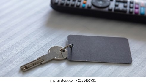 Door Key With Blank Tag. Steel Key Ring, Room Key And Empty Black Label For Text Or Number Close Up View. House, Hotel Or Motel Room Open, Unlock Concept. Copy Space, Template