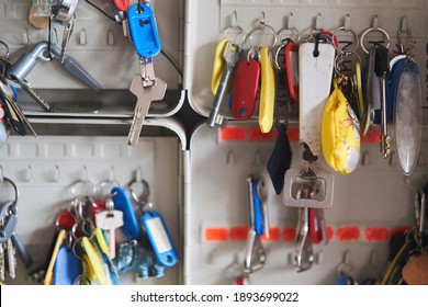 Door Keys. Many Keys With Multi-colored Key Chains Hang In The Key Keeper.