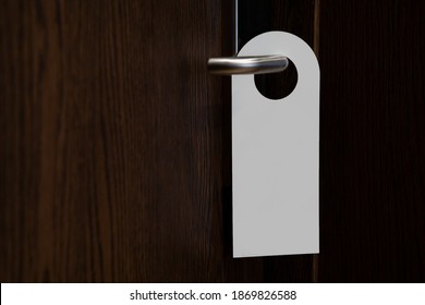 Door knob with blank doorhanger mock up. Empty white flyer mockup hang on door handle. Leaflet design. Dont disturb sign. Hotel room clear hanger. Do not disturbing signal.