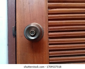 Door Knob And Brown Wood Bathroom Door