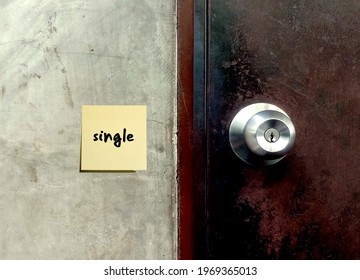 Door Knob And A Note On Cement Background With Note Written SINGLE , Concept Of Individual Person, Being Alone  , Unmarried Or Not Involved In A Stable Sexual Relationship.