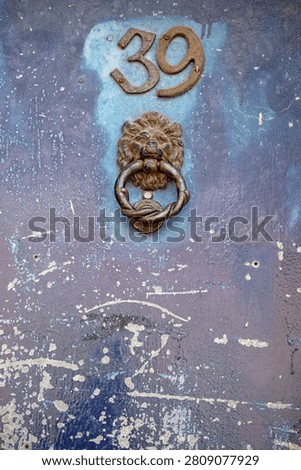 A door knocker is a device fixed to a door that allows people outside to alert those inside by making a noise when it is struck. It typically consists of a metal part that is lifted and used to hit a plate or the door itself.