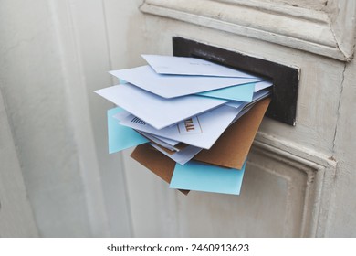 Door, letter and mail or envelope in box of home for communication or notice, stacked and overflowing with documents. Mailbox, post and address for mortgage or debt, message and paper from bank.