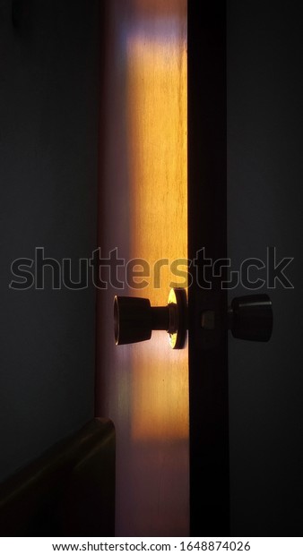 door with a light shadow and a metal lock\
dividing the inside from the\
outside
