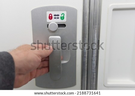 Door Lock button for Toilet on the plane. close up
