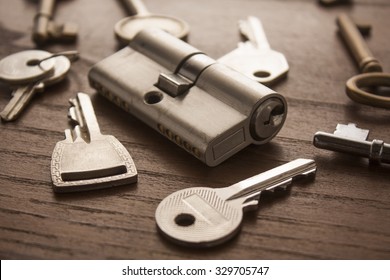 door lock with keys on wooden surface
