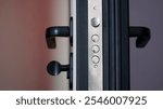 Door lock on an open armored entrance door. Latch and metal bolt on the door lock. Rubber tubular seals for door sealing. Apartment and house protection. Photo. Close-up