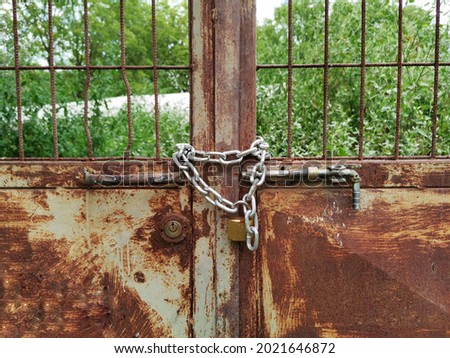 Door locked with chain. Rusted door. Iron garden gate.