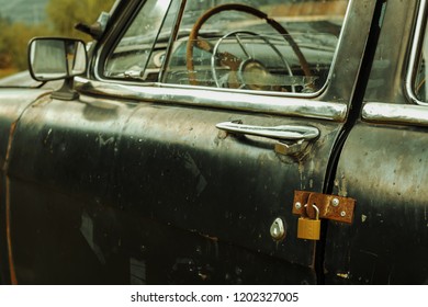 The Door Of The Old Car Is Closed On The Barn Lock. Stupid Idea To Repair.