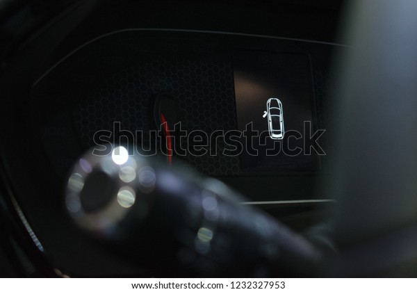 Door\
open warning light on car dashboard. Close up shot open doors car\
warning signs. Monitor system, close and open door notification.\
Car dashboard against the steering wheel\
background