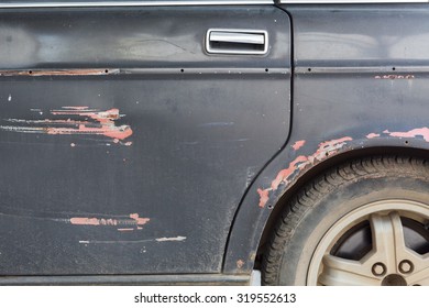 Door Panel Of Old Car,  Focus On Paint And Rusty Damaged From Crash Accident.