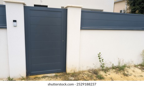 door pedestrian grey metal home gate at entrance of house garden  - Powered by Shutterstock