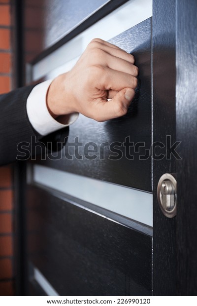 Door to door\
salesman knocking on the\
door