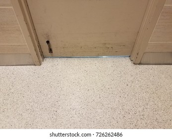 Door With Scuff Marks And Kickstand And White Floor