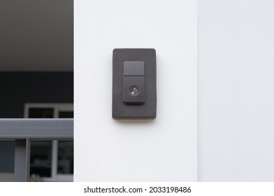 Doorbell button with visiter ringing buzzer doorbell. Guest press bell behind front door home.
